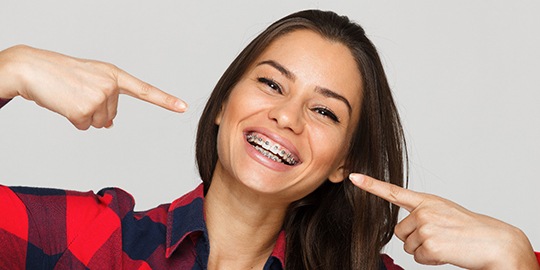 woman with braces, whose dental insurance covered treatment