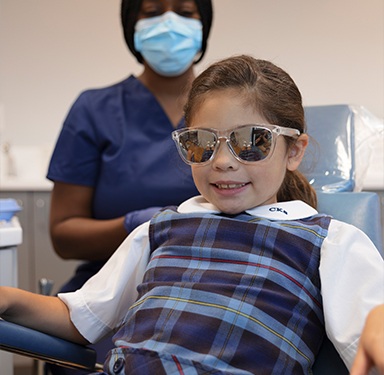 Child in orthodontic chair smiling