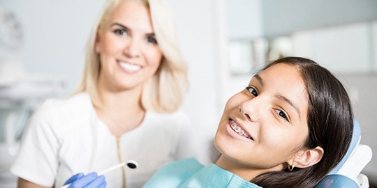 A girl with braces at the dentist’s office