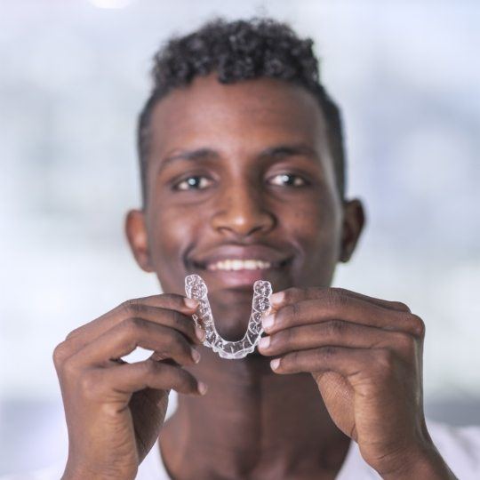 Man placing an adult orthodontics tray