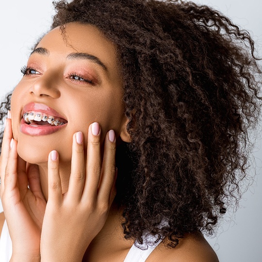 smiling patient with braces in Atlanta who understands the cost of traditional braces