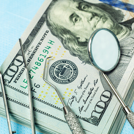 dental tools and money on table