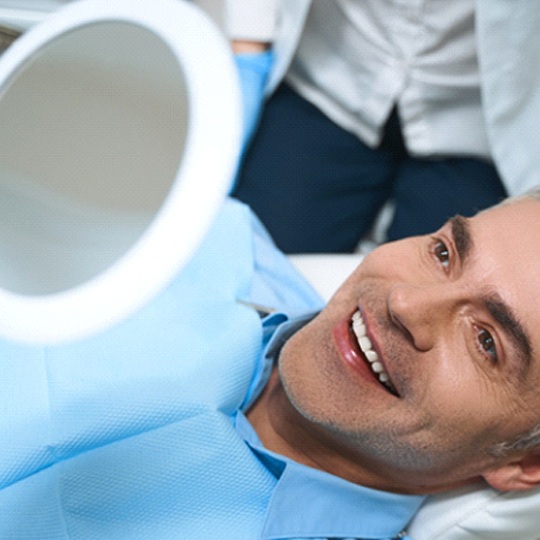 Man admiring his smile after teeth whitening in Atlanta