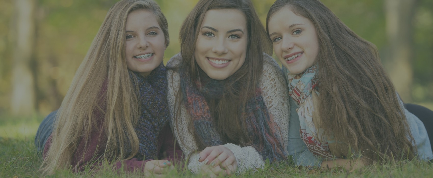 Three teens with braces smiling after visiting their orthodontist in Atlanta Georgia