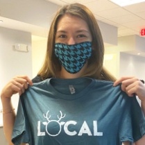Orthodontic patient holding up a local shirt
