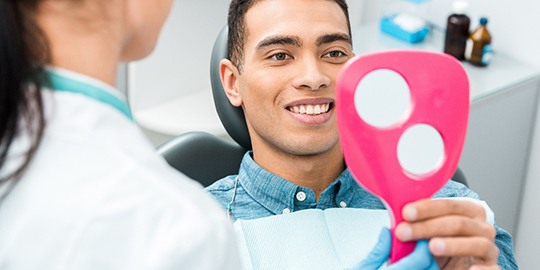Man smiling in home office