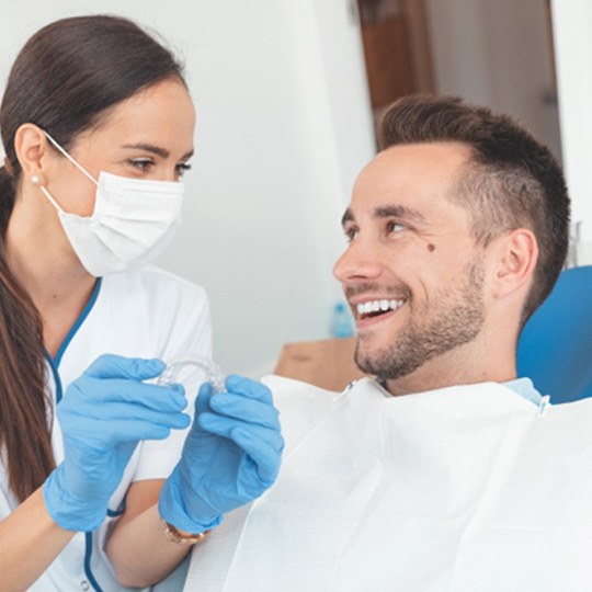 Patient and dentist discussing cost of Invisalign in Atlanta