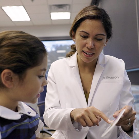 Doctor Everson talking to young dental patients