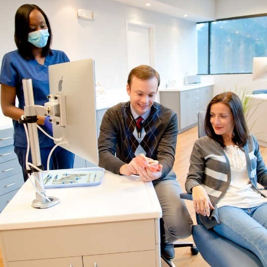 Doctor Everson and team member talking to orthodontic patient