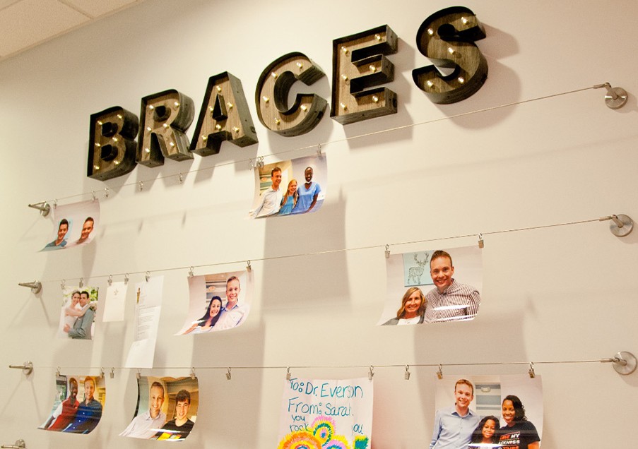 Picture of orthodontist and patients on orthodontic office wall