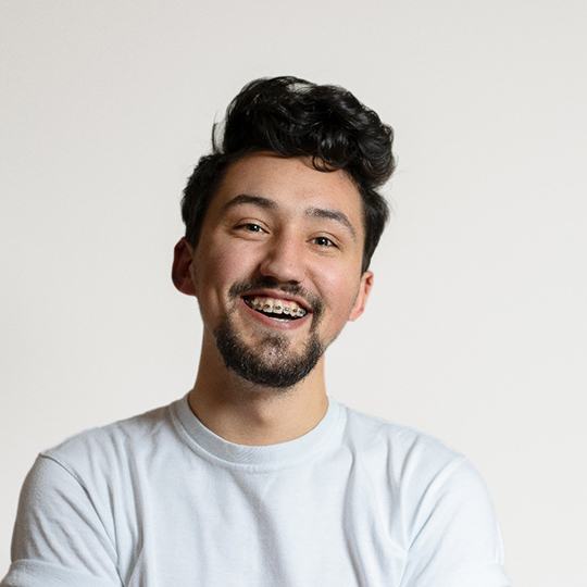 Smiling man with braces in Atlanta on white background