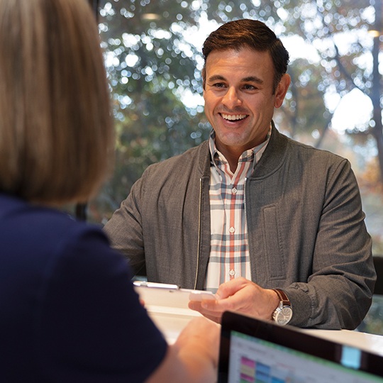 Man filling out orthodontic insurance forms