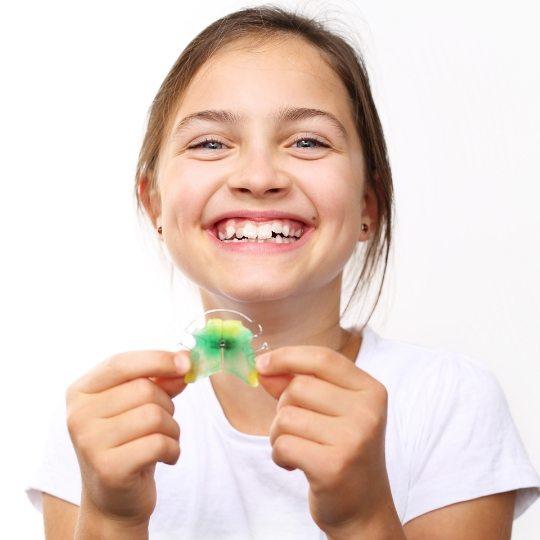 Orthodontic patient holding a retainer