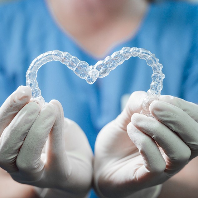 Closeup of Spark Clear Aligners in Atlanta in heart shape