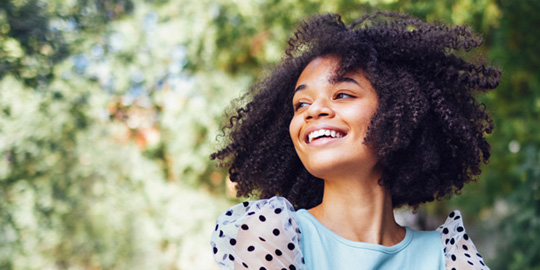 Teen girl smiling outside