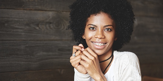 Smiling woman enjoying the advantages of ceramic braces