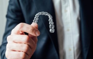 man with clear aligners